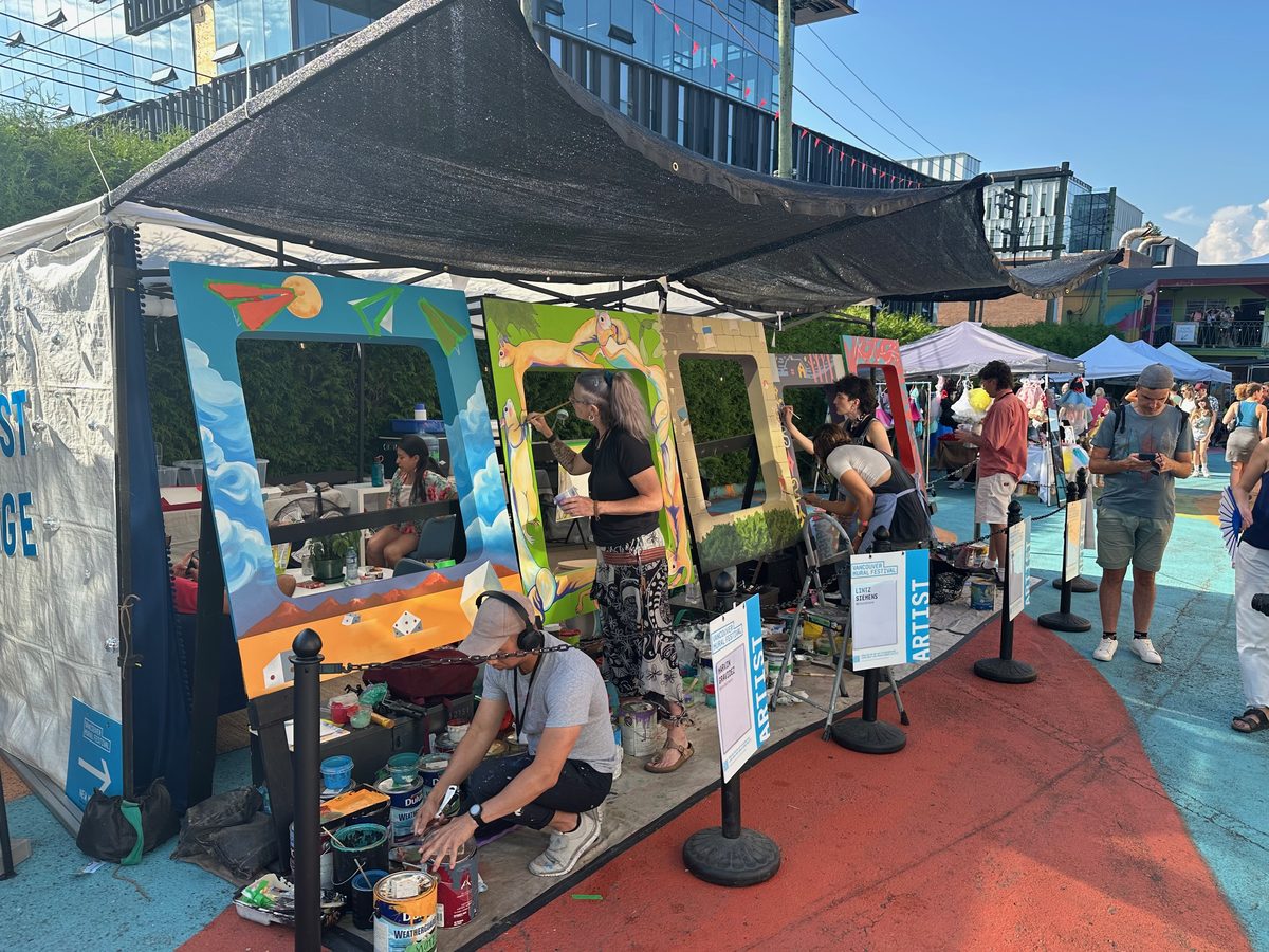 Artists painting large frames at Vancouver Mural Festival